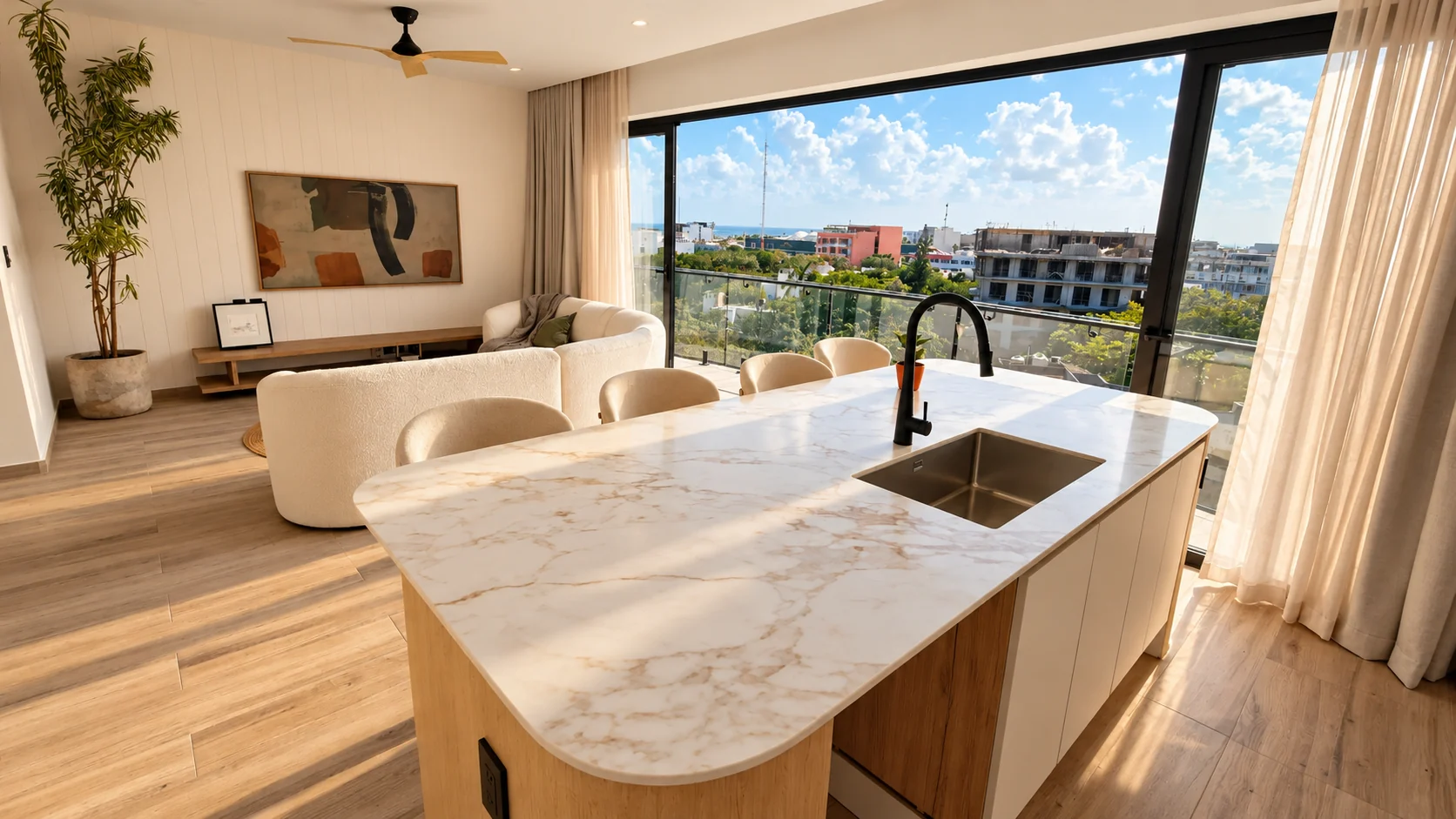 Two-bedroom residence at Luna with a marble kitchen island, living room and floor-to-ceiling windows overlooking Playa del Carmen